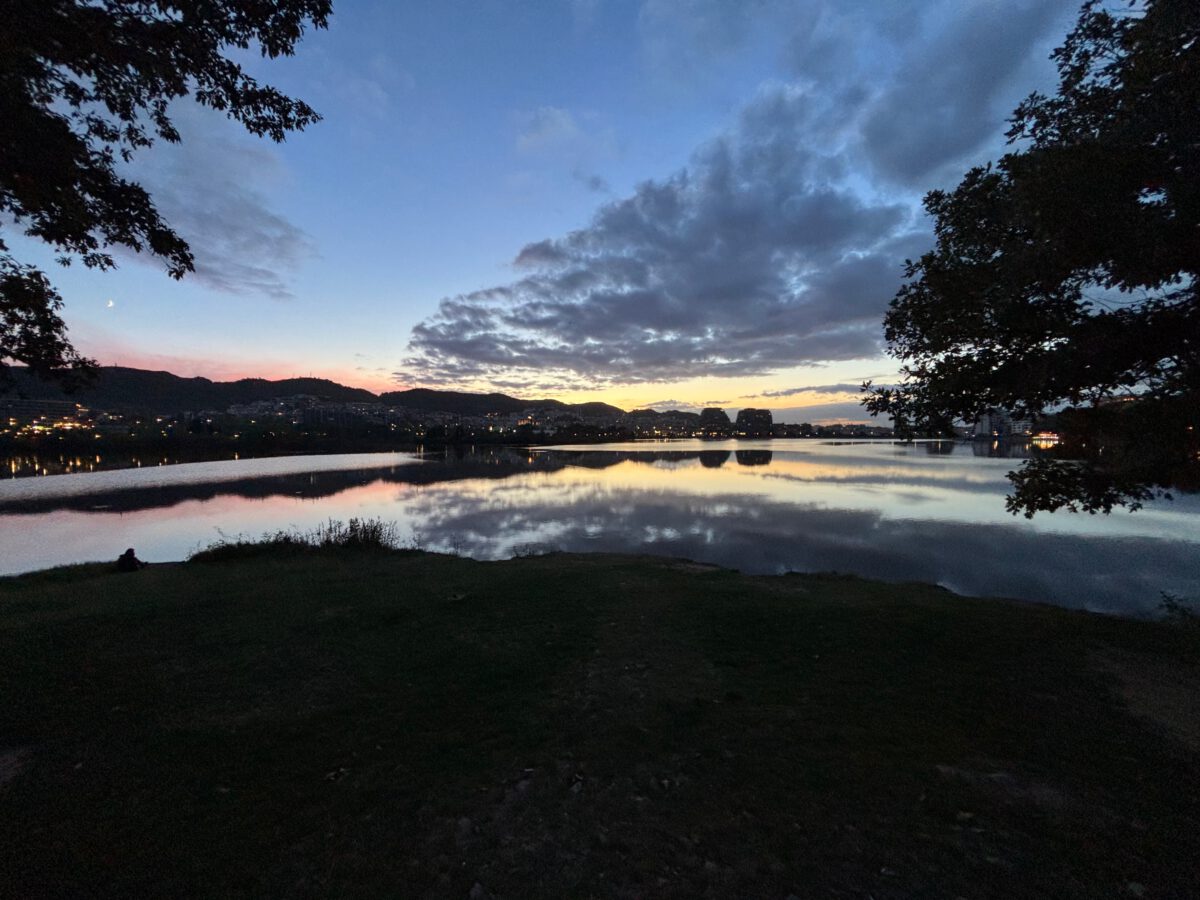 Grimy side street with neon sign in central Tirana